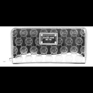 Michael Kors silver metallic wallet.